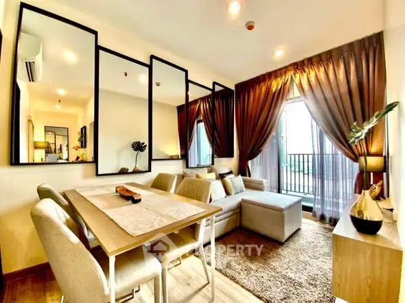 Stylish living room with modern decor and large mirrors enhancing space.