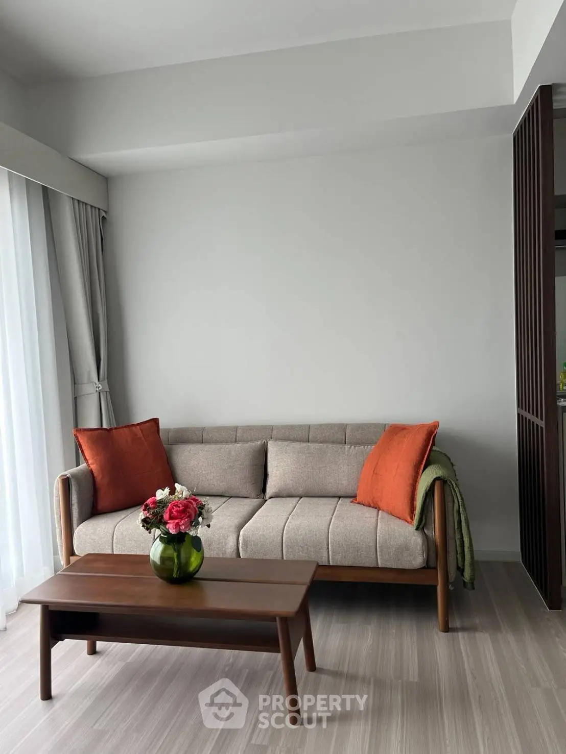 Modern living room with stylish sofa and coffee table, featuring elegant decor and natural light.