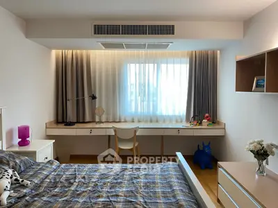 Modern bedroom with stylish decor and large window, featuring a cozy bed and functional workspace.