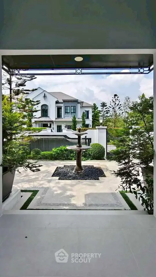Luxurious modern home with elegant landscaping and grand entrance view.