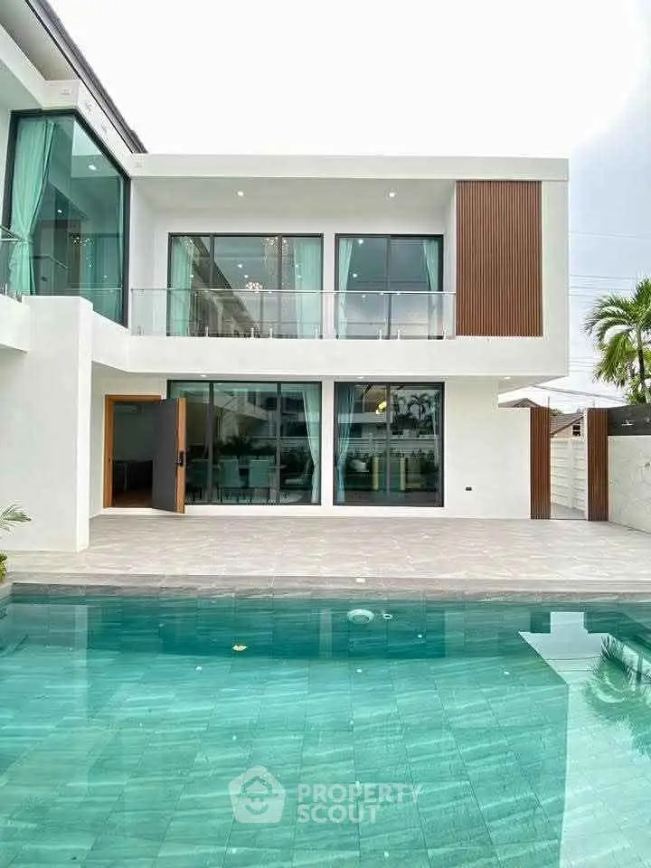 Luxurious modern villa with a stunning pool and spacious balcony, perfect for upscale living.