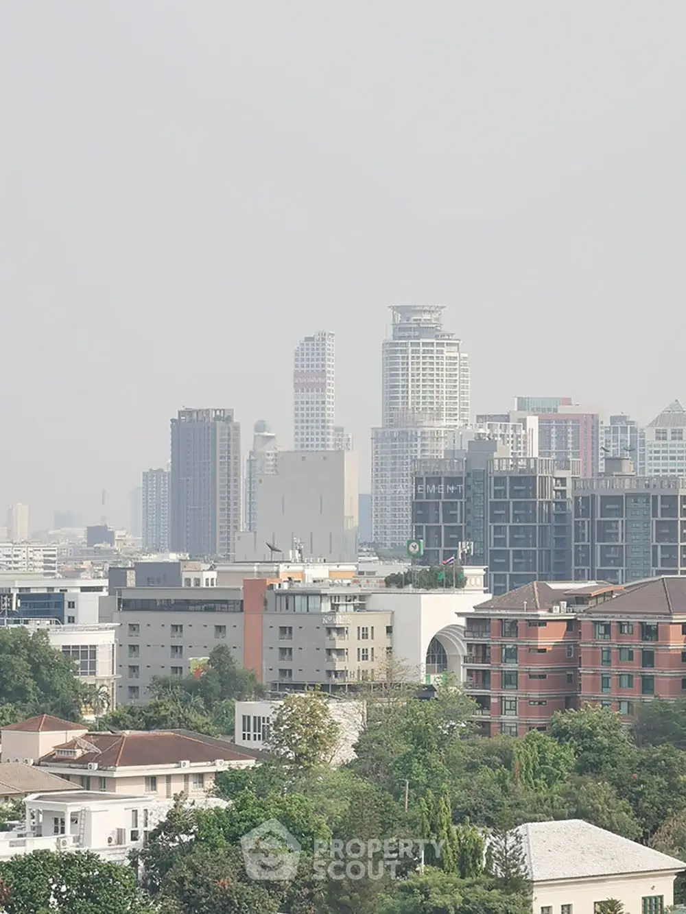 Stunning cityscape view showcasing modern high-rise buildings and lush greenery, perfect for urban living.