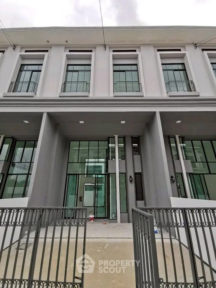 Modern townhouse exterior with large windows and elegant facade