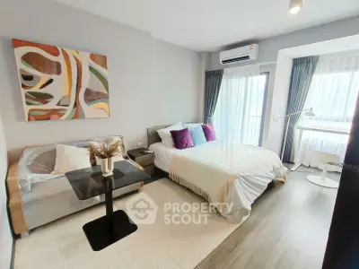 Modern bedroom with stylish decor, featuring a cozy bed, elegant sofa, and large windows for natural light.