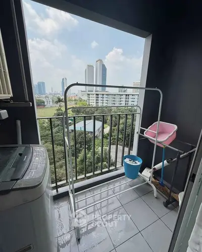 Charming balcony with city view, perfect for laundry and relaxation in urban apartment.