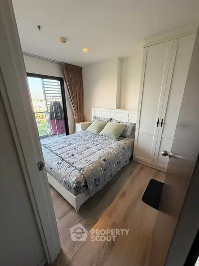 Cozy bedroom with balcony access and stylish decor in modern apartment.