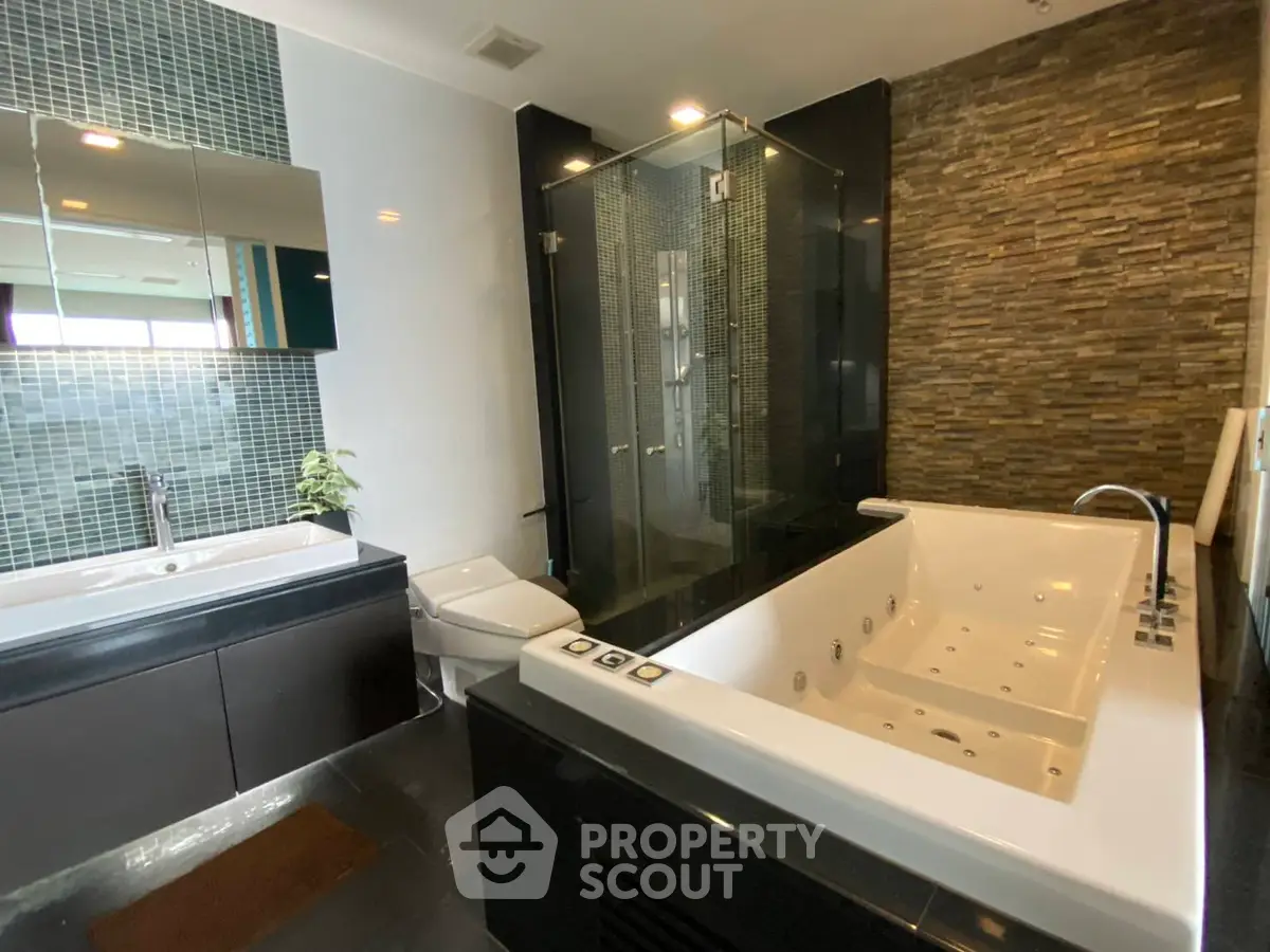 Luxurious bathroom with modern jacuzzi and elegant stone wall design