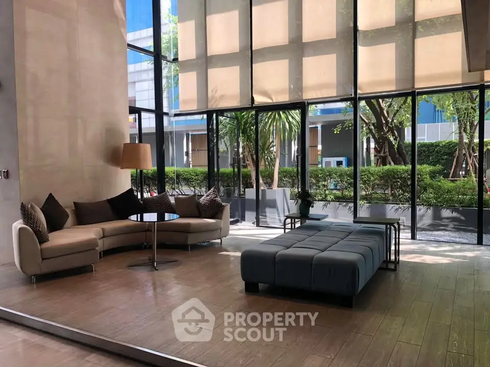 Luxurious modern lobby with floor-to-ceiling windows and stylish seating area.