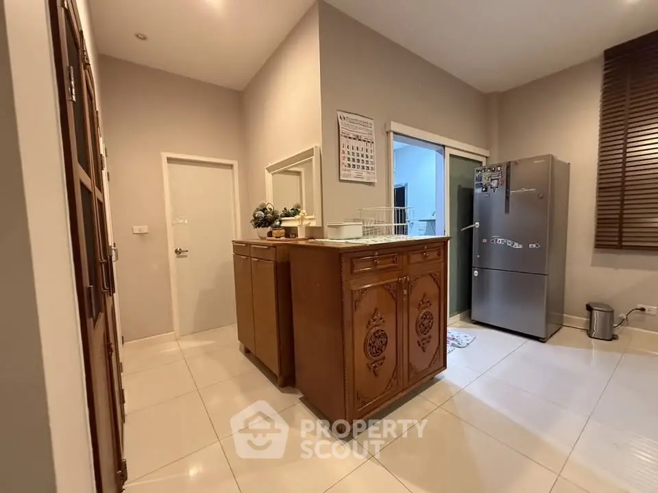 Spacious kitchen with modern fridge and elegant wooden island