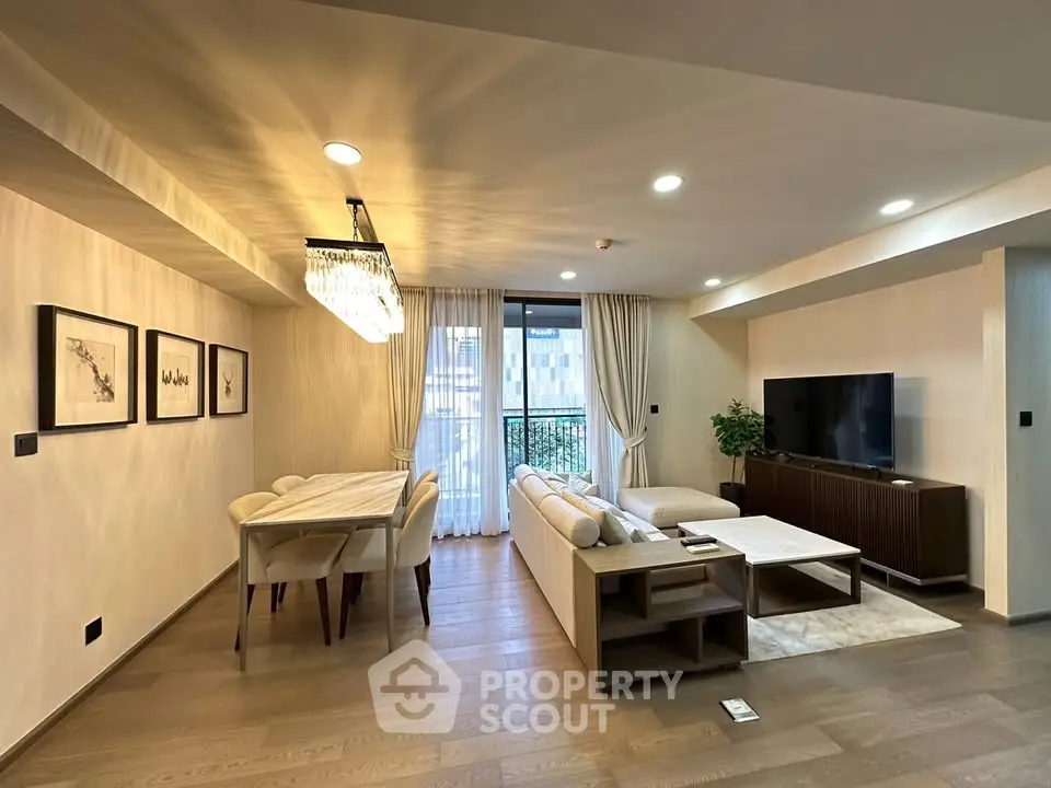 Spacious modern living room with elegant dining area and large TV setup, perfect for entertaining.