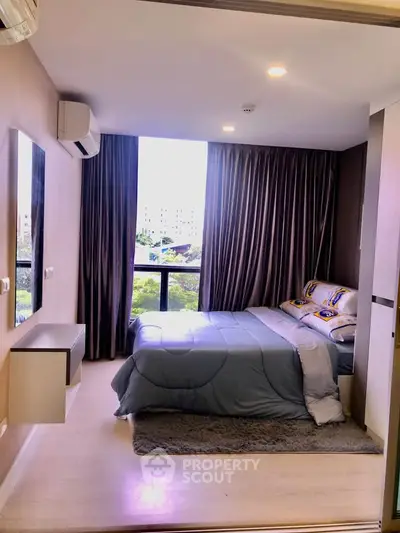 Modern bedroom with large window and stylish decor in a high-rise apartment.