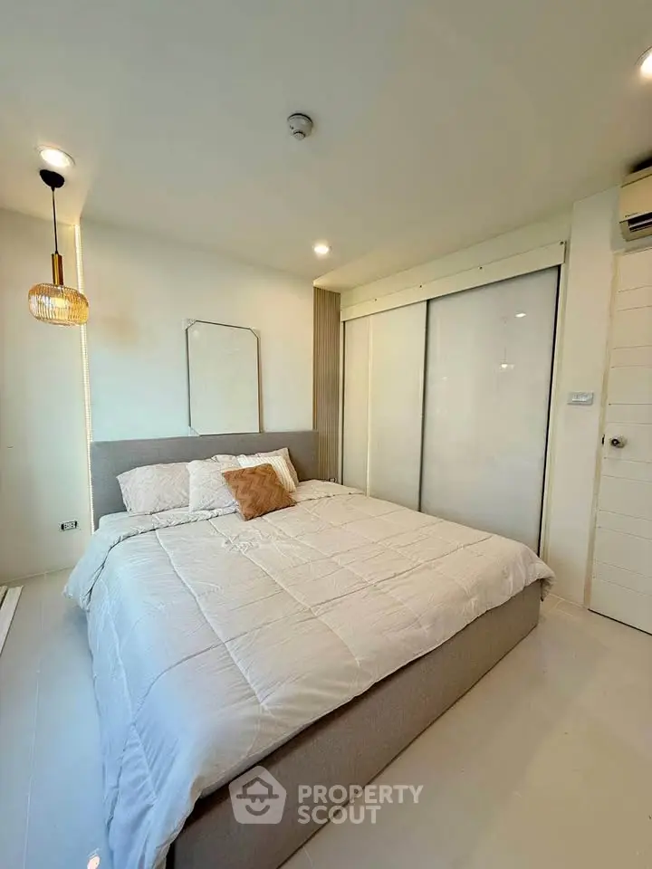 Modern bedroom with cozy bed and stylish lighting in a bright apartment