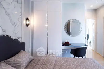 Elegant bedroom with marble walls, chic furnishings, and modern lighting, perfect for upscale urban living.