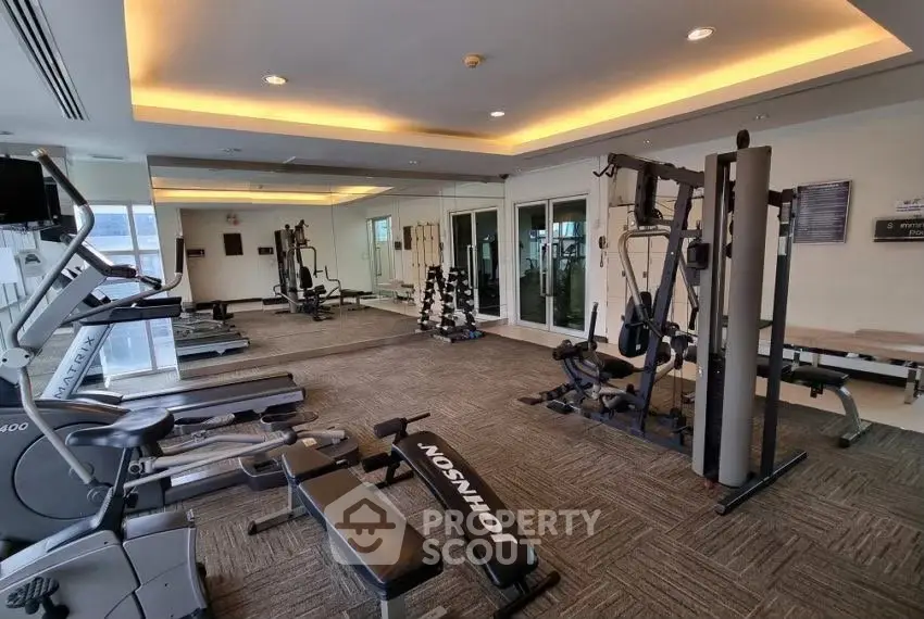 Modern gym with state-of-the-art fitness equipment in a residential building.