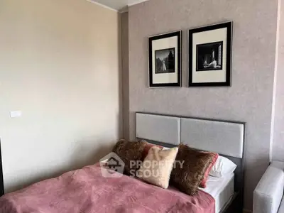 Cozy bedroom with stylish decor and plush bedding in modern apartment.
