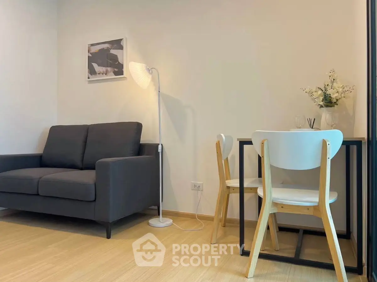 Modern living room with cozy sofa and dining area, perfect for urban living.