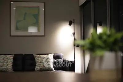 Stylish modern living room with black leather sofa and elegant lighting