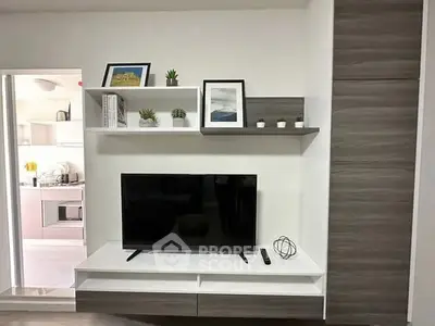 Modern living room with sleek TV unit and stylish decor, showcasing contemporary interior design.