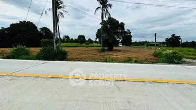 Expansive plot of land with lush greenery and clear skies, ideal for development opportunities.
