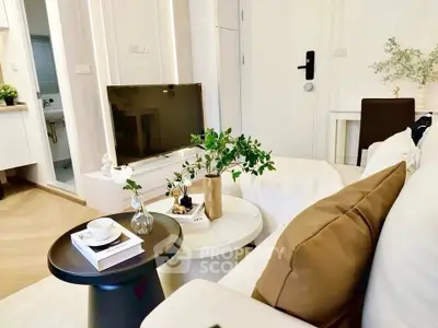 Modern living room with stylish decor and flat-screen TV, perfect for relaxation and entertainment.