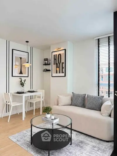 Modern living room with stylish decor and dining area, featuring a cozy sofa and elegant artwork.