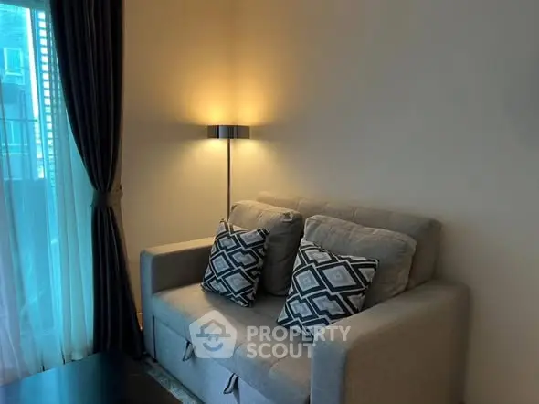 Cozy living room with stylish sofa and elegant lighting, perfect for relaxation.