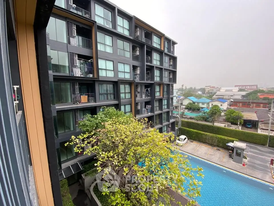 Modern apartment building with pool and city view