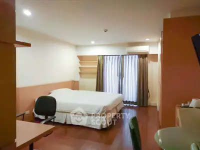 Spacious bedroom with modern furnishings and natural light