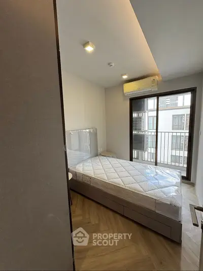 Modern bedroom with large window and air conditioning unit