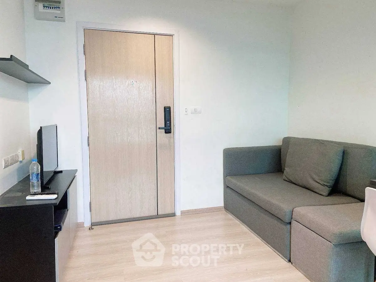 Modern living room with sleek sofa and TV setup, perfect for cozy relaxation.