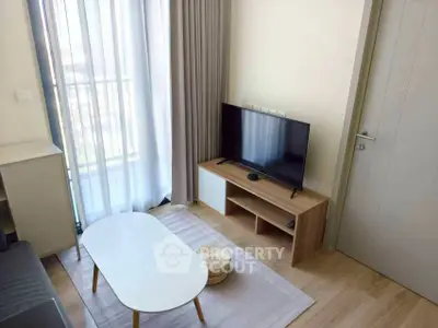 Cozy modern living room with TV and natural light