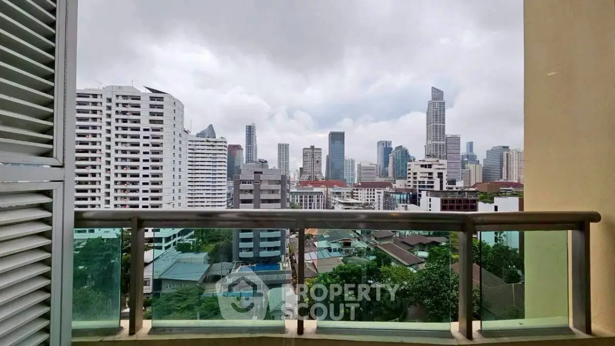 Stunning cityscape view from a modern balcony in a high-rise apartment.