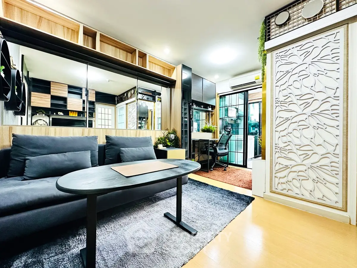 Modern living room with sleek design and stylish decor, featuring a cozy sofa and elegant partition.