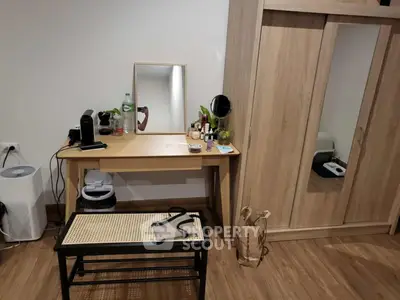 Cozy bedroom with wooden wardrobe and vanity desk, perfect for modern living.