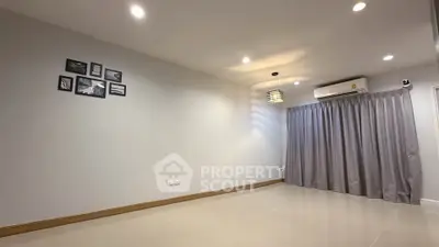 Spacious empty room with modern lighting and air conditioning, ideal for customization.
