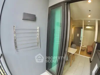 Modern apartment balcony with sliding glass doors and interior view