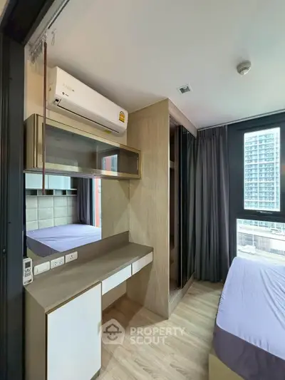 Modern bedroom with built-in wardrobe and large window offering city view