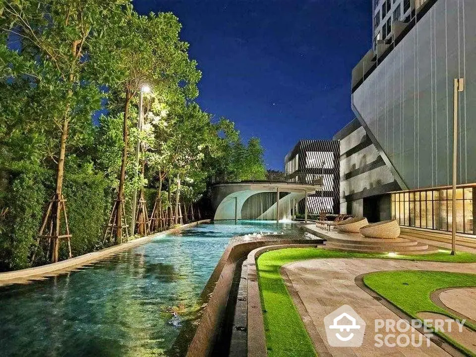 Luxurious modern apartment with stunning pool and lush greenery at night