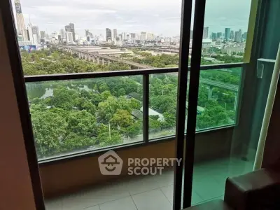 Stunning cityscape view from high-rise balcony with lush greenery and urban skyline.