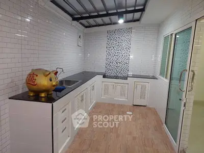 Modern kitchen with sleek countertops and stylish backsplash in a bright, open layout.