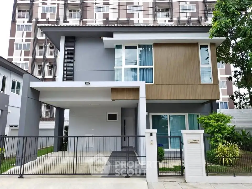 Modern two-story house with sleek design and spacious driveway in urban setting.