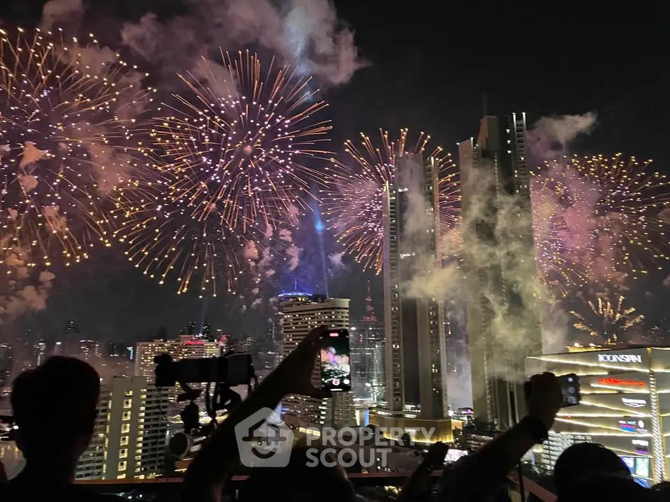 Spectacular city skyline with vibrant fireworks illuminating the night sky, showcasing urban luxury living.