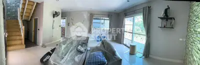 Spacious living room with modern decor and large windows for natural light.