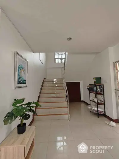 Modern interior with staircase and stylish decor in spacious hallway