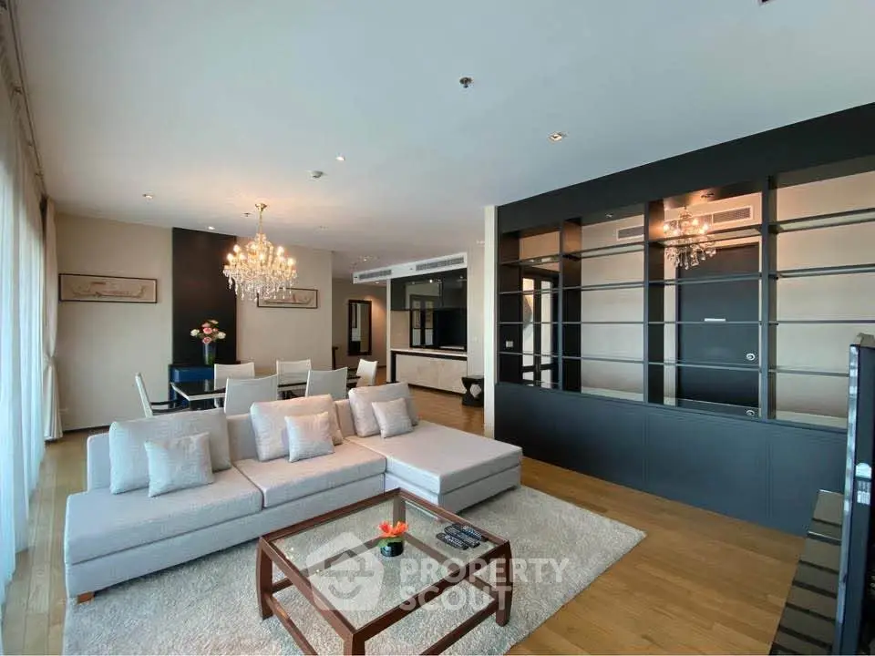 Spacious modern living room with elegant decor and open layout, featuring a cozy seating area and dining space.
