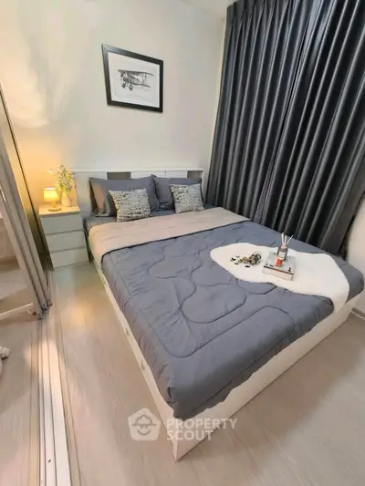 Cozy bedroom with modern decor and elegant curtains, perfect for relaxation and comfort.