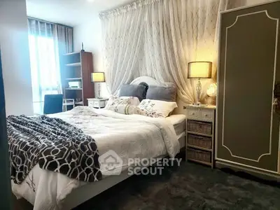 Cozy bedroom with elegant decor and ample natural light, featuring a comfortable bed and stylish furniture.