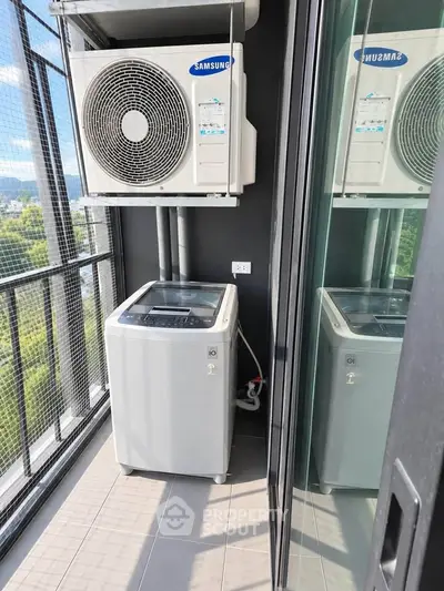 Modern balcony with washing machine and air conditioning unit in high-rise apartment.
