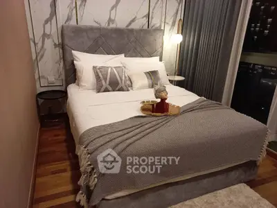 Luxurious bedroom with elegant decor and city view, featuring plush bedding and stylish lighting.