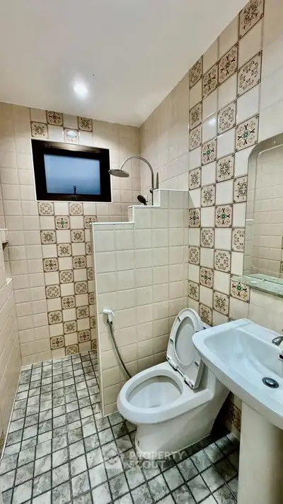Charming vintage bathroom with patterned tiles and modern fixtures